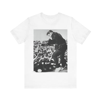 A black graphic t-shirt featuring a retro photo of Elvis Presley performing live in concert in the 1950s.