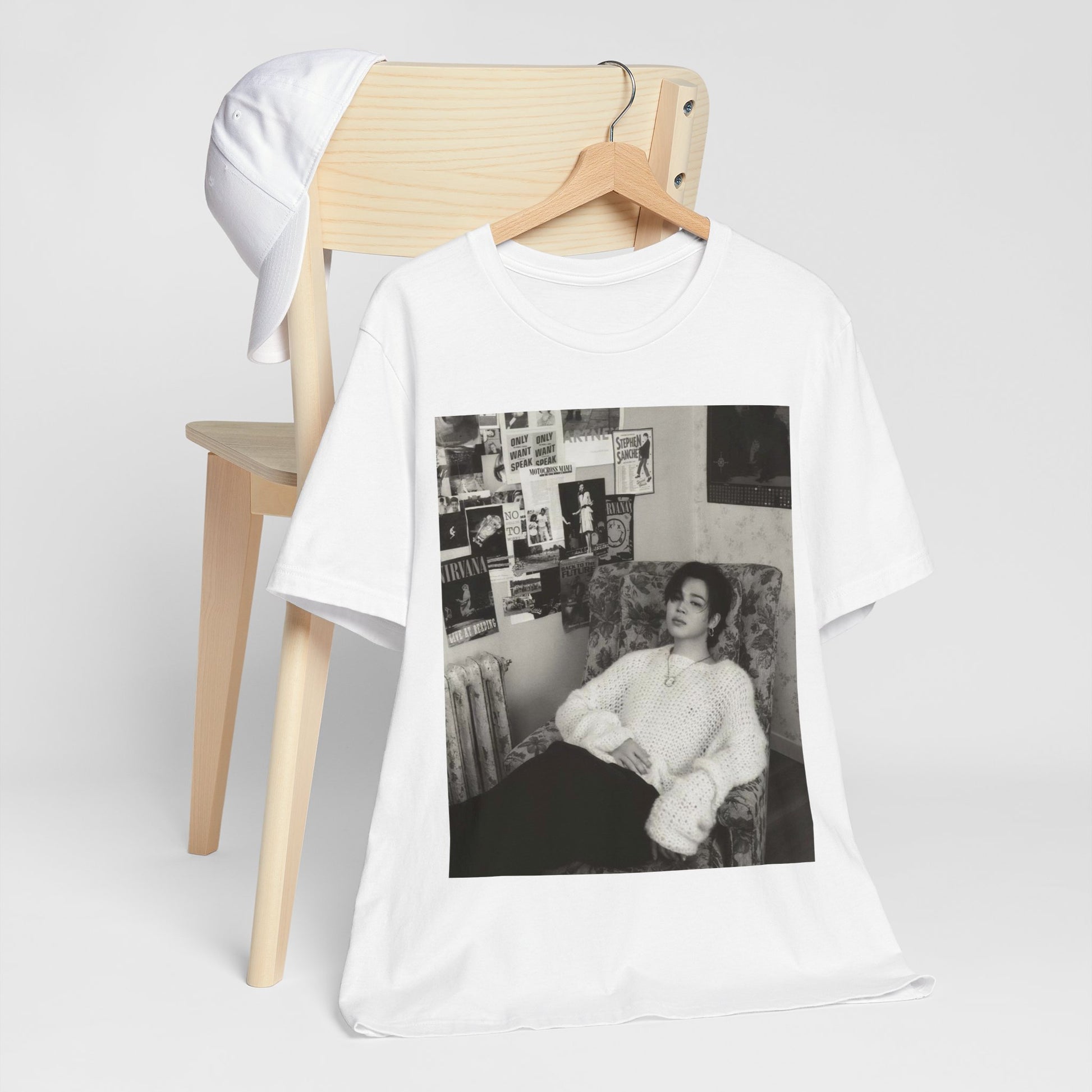 A black graphic t-shirt featuring a black and white portrait photo of Jimin.