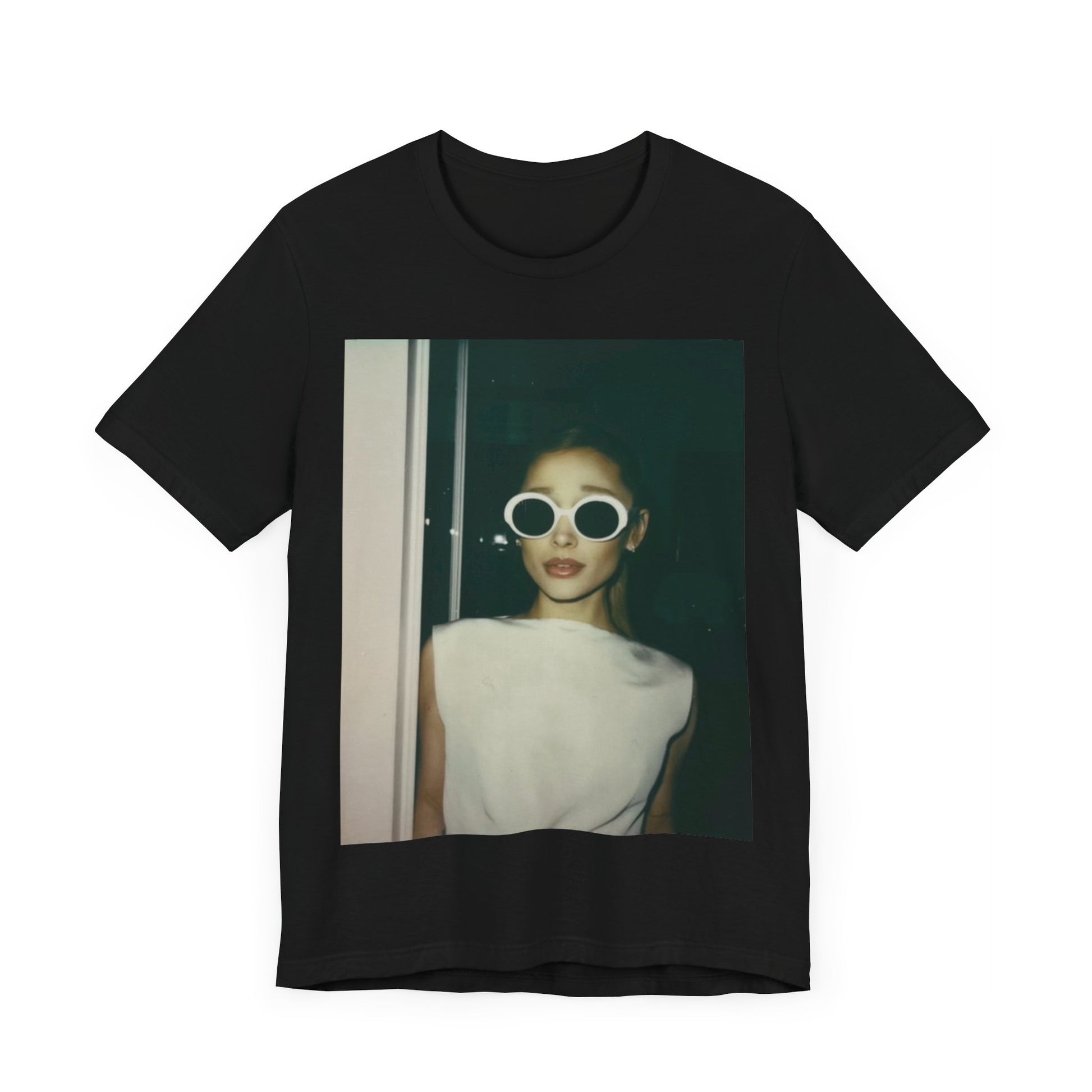 A black graphic t-shirt featuring a retro Polaroid-style photo of Ariana Grande.