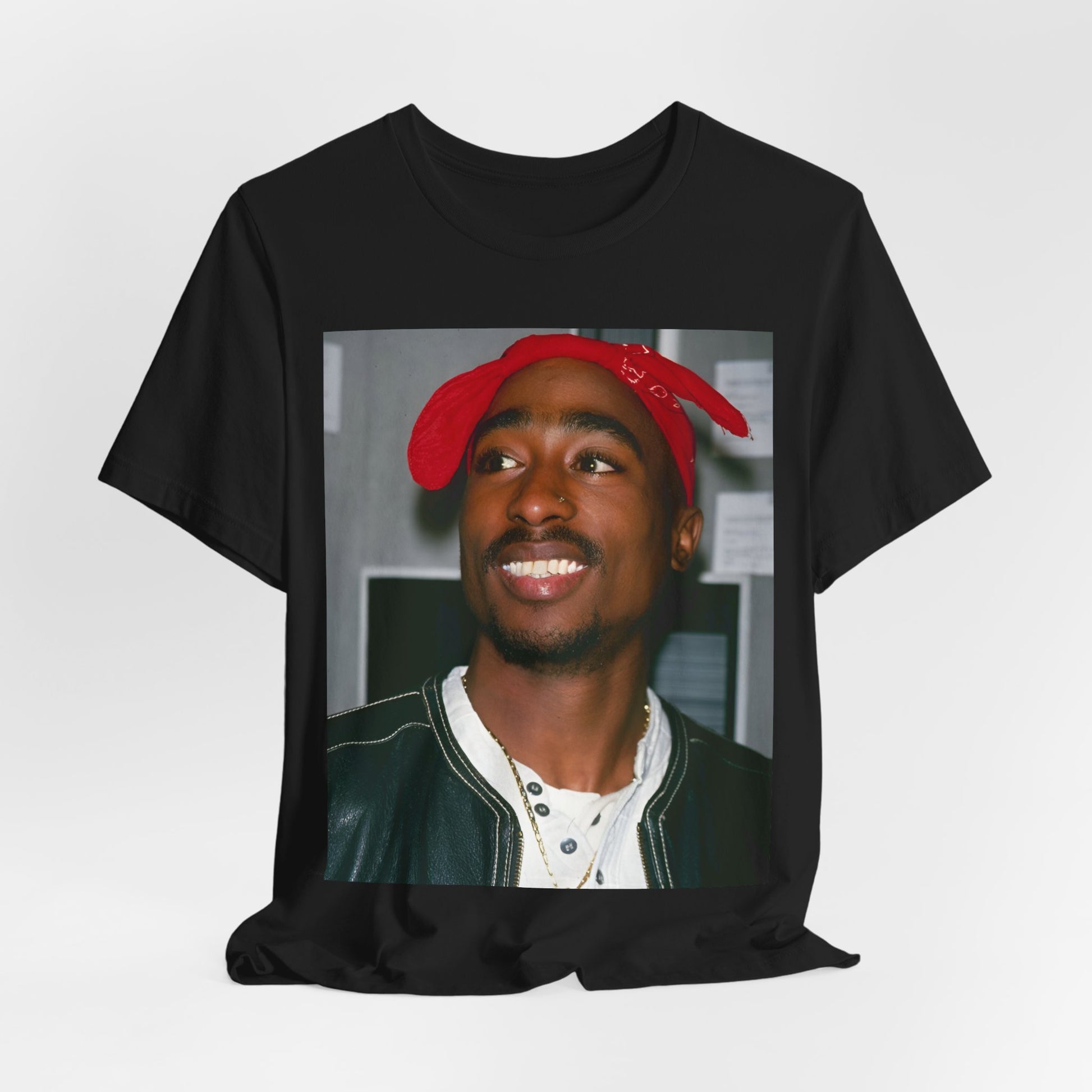 A black graphic t-shirt featuring a graphic of Tupac with his iconic bandana style.