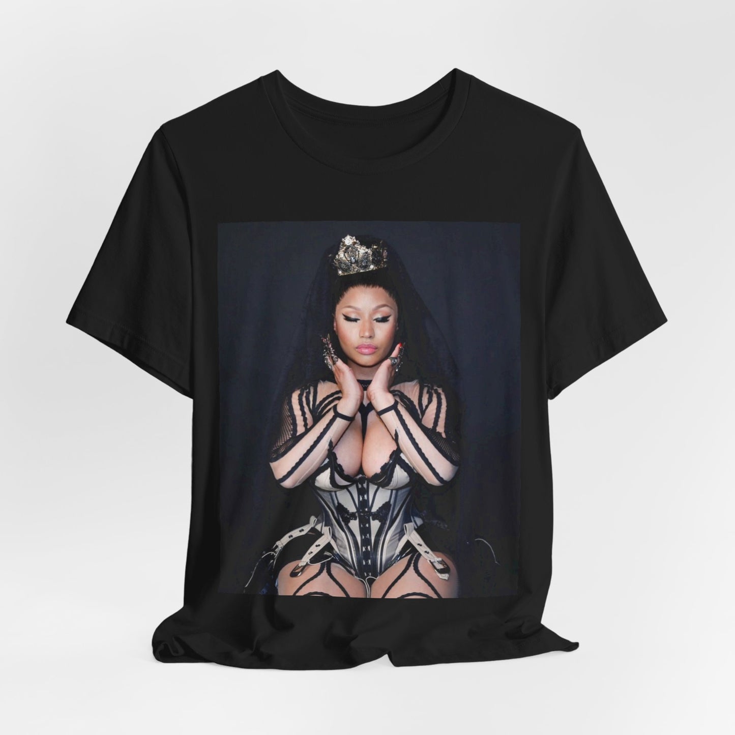 A black graphic t-shirt featuring a vintage graphic of Nicki Minaj as the Queen of Rap.
