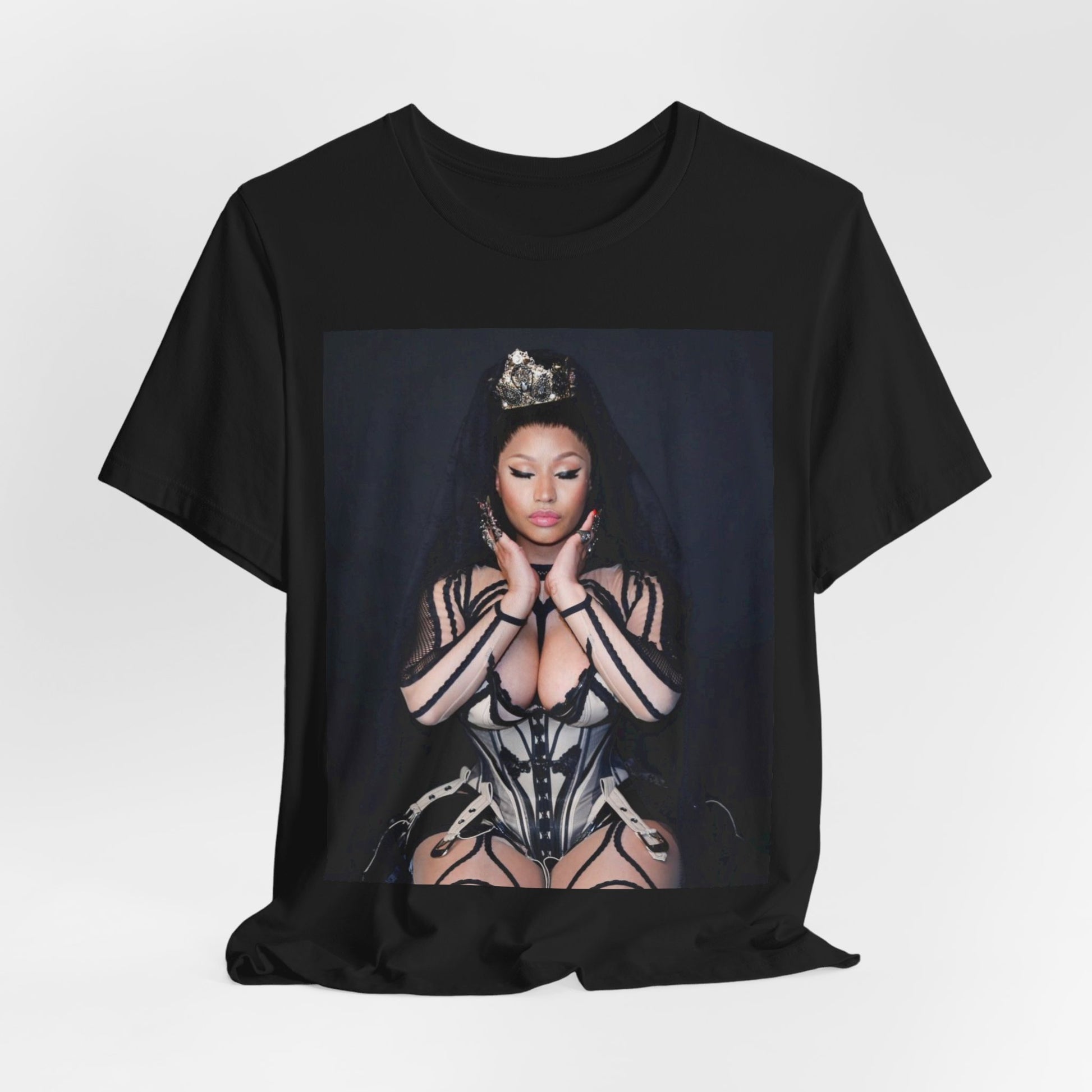 A black graphic t-shirt featuring a vintage graphic of Nicki Minaj as the Queen of Rap.