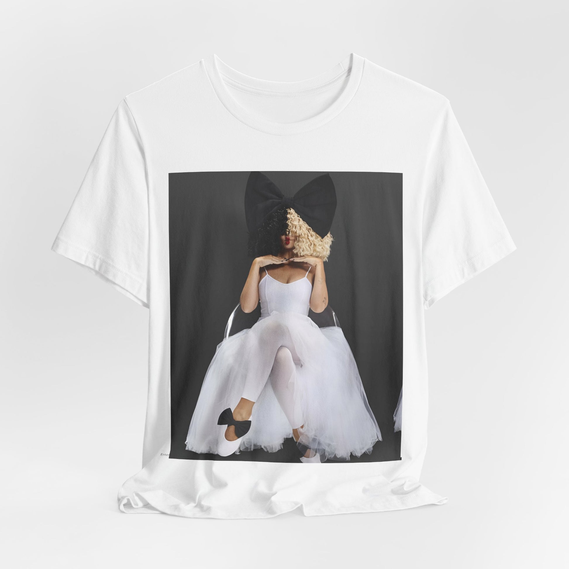 A black graphic t-shirt featuring a graphic of Sia's iconic wig style.