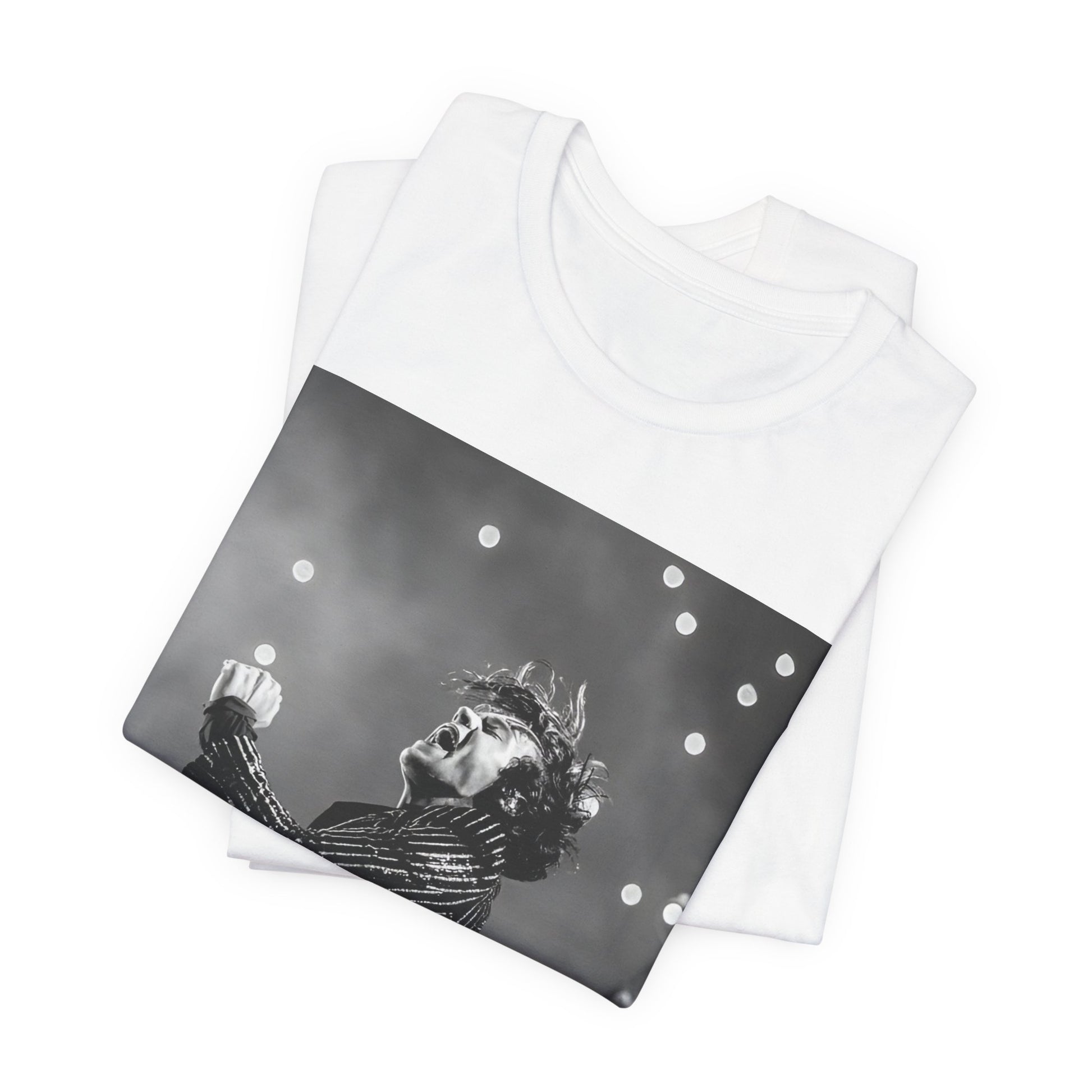 A black graphic t-shirt featuring a glamorous graphic or photo of Harry Styles performing on stage.