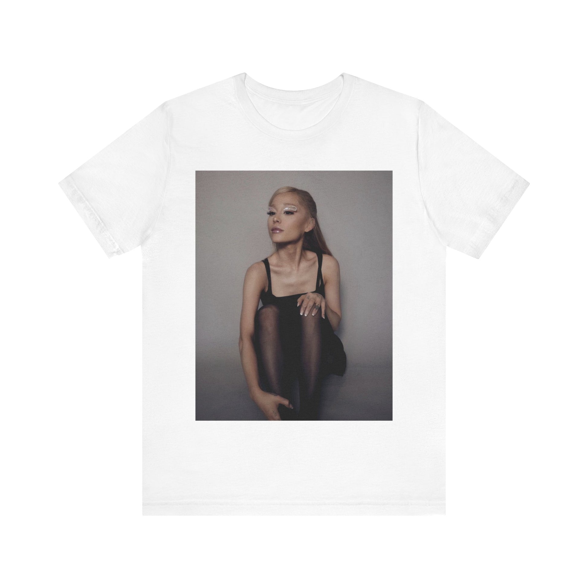 A black graphic t-shirt featuring a bold and beautiful graphic of Ariana Grande, emphasizing her strong and confident presence.