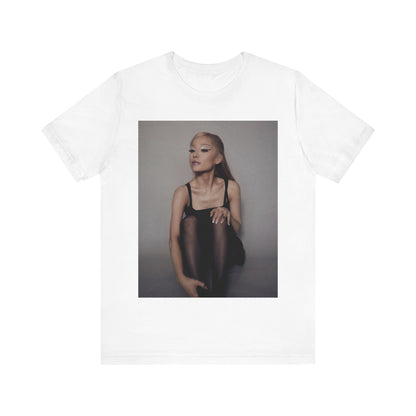 A black graphic t-shirt featuring a bold and beautiful graphic of Ariana Grande, emphasizing her strong and confident presence.