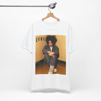 A black graphic t-shirt featuring a bold goth rock superstar graphic of The Cure.