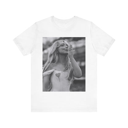 A black graphic t-shirt featuring a graphic or photo of Sabrina Carpenter kissing on stage during a performance.