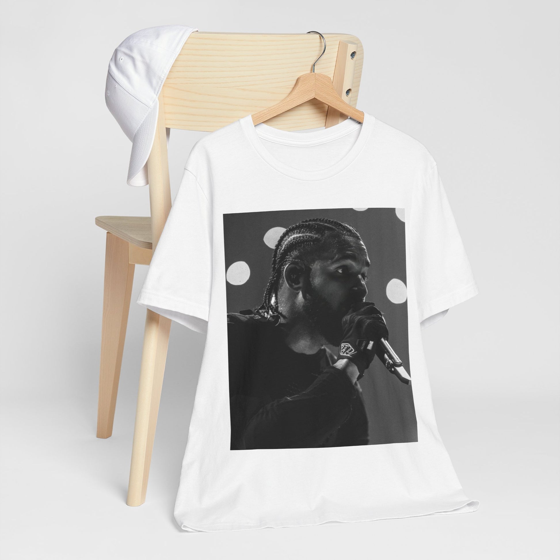 A black graphic t-shirt featuring a classic black and white style graphic of Drake.