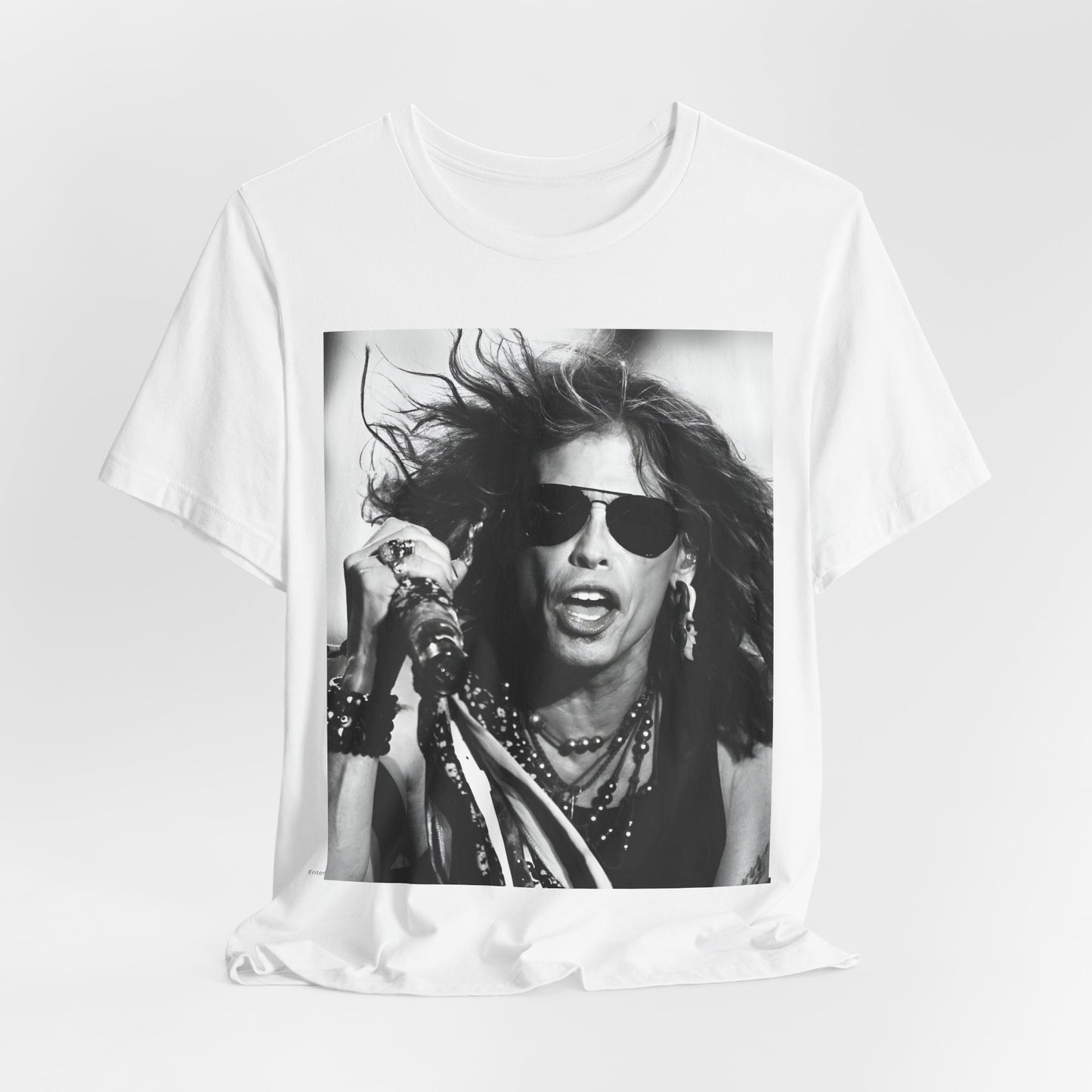 A black graphic t-shirt featuring a black and white photo of Aerosmith's Steven Tyler with his signature scarf and microphone, captured during a dynamic performance.
