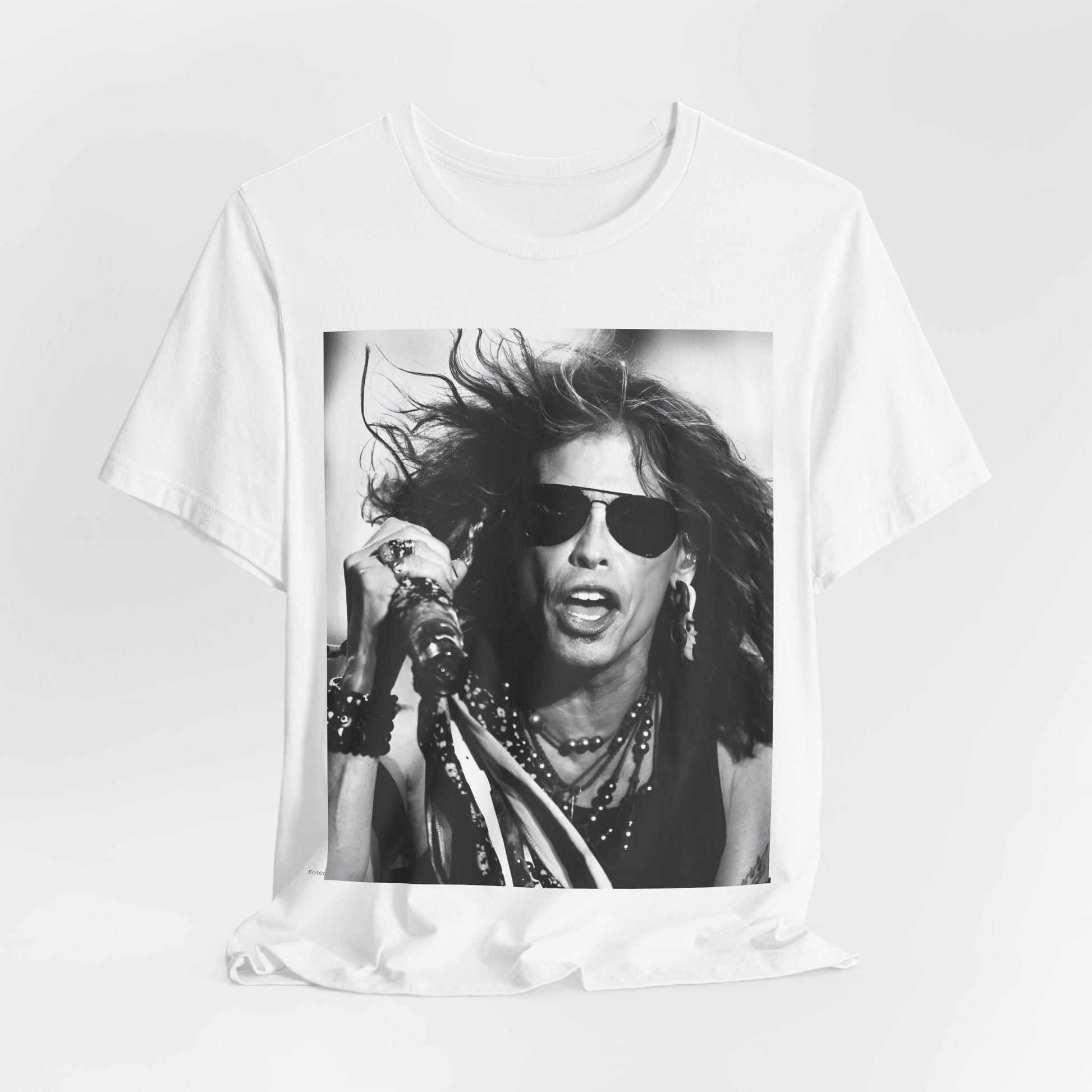 A black graphic t-shirt featuring a black and white photo of Aerosmith's Steven Tyler with his signature scarf and microphone, captured during a dynamic performance.