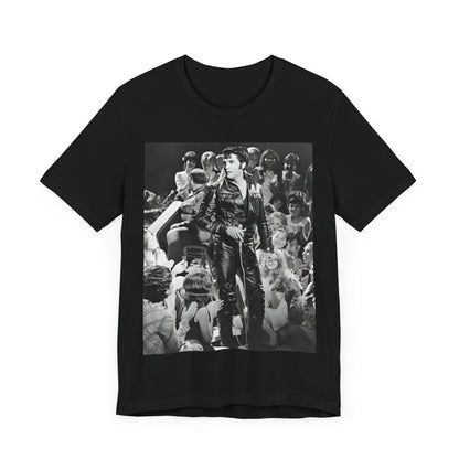 A black graphic t-shirt featuring a vintage black and white photo or graphic of Elvis Presley performing live on stage.