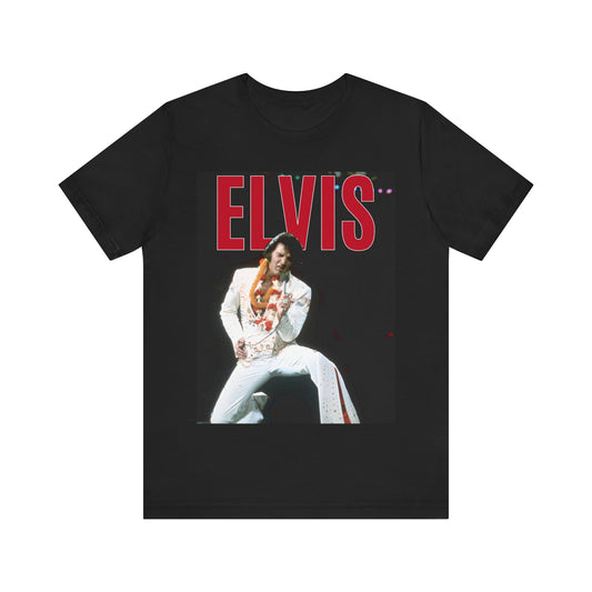 A black graphic t-shirt featuring a glamorous graphic or photo of Elvis Presley on a Las Vegas stage.