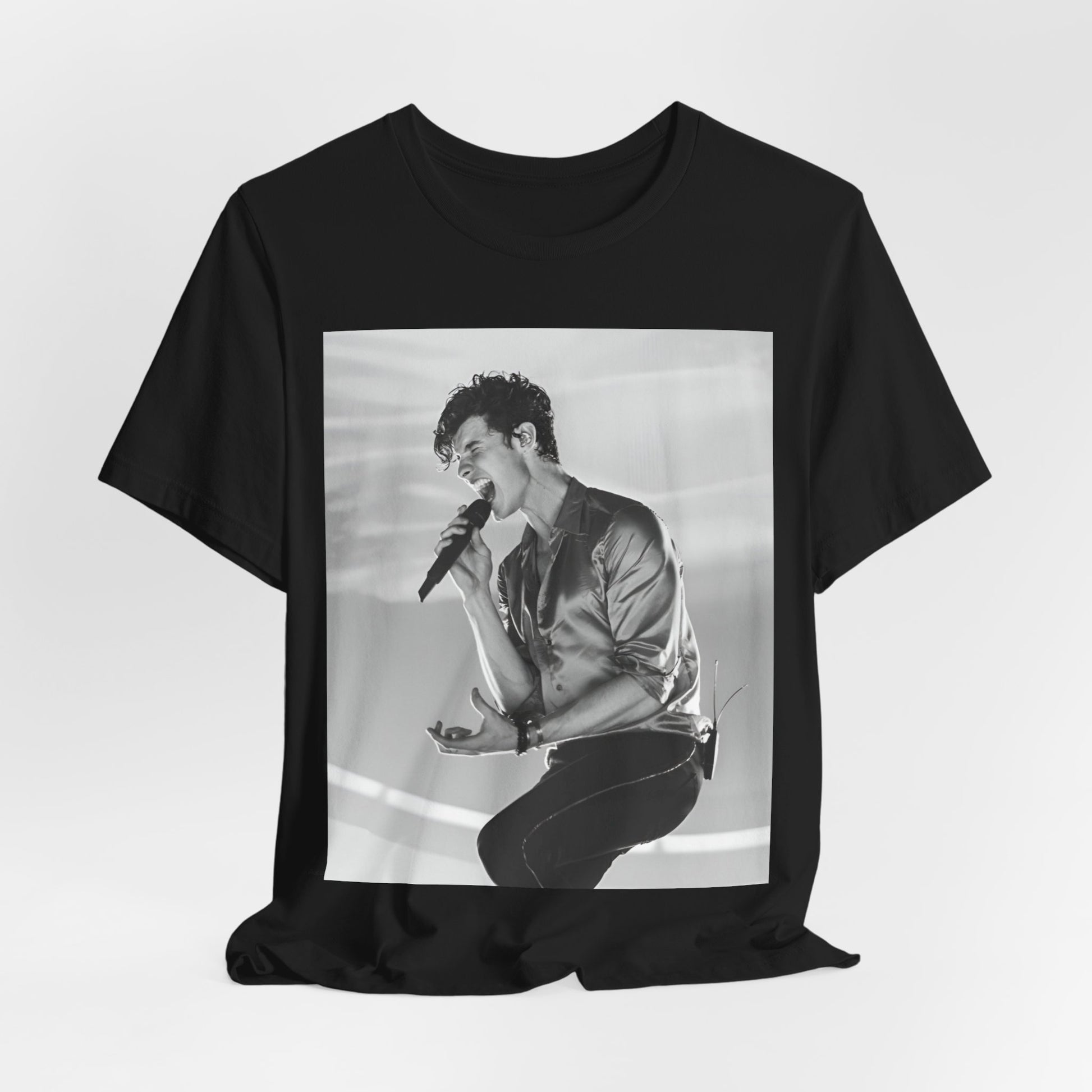 A black graphic t-shirt featuring a black and white graphic or photo of Shawn Mendes as a dreamy pop star.