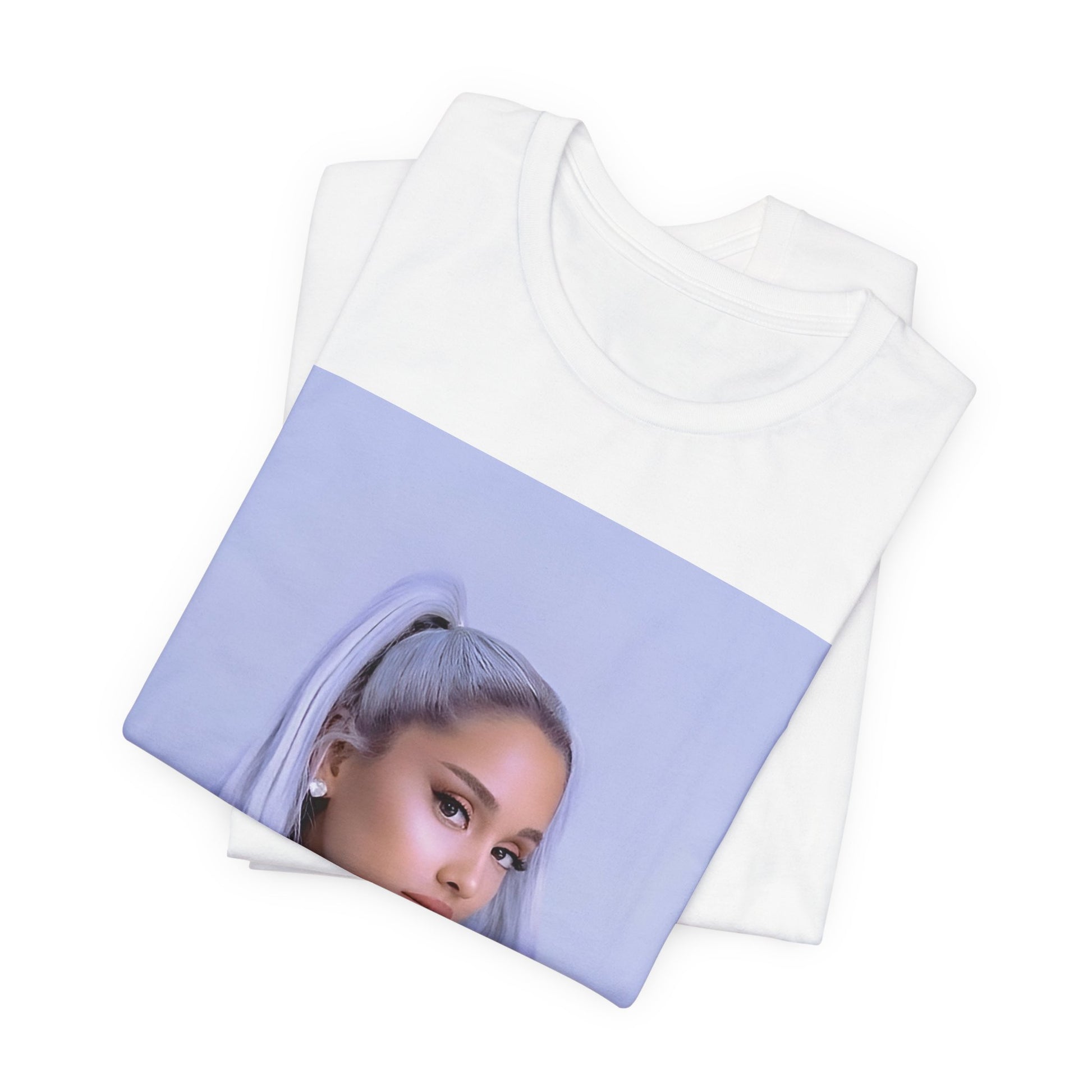 A black graphic t-shirt featuring a stylized graphic of Ariana Grande, possibly with a crown or 'Pop Queen' text, emphasizing her iconic status.