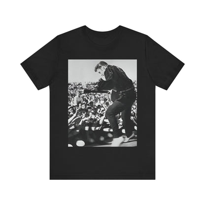 A black graphic t-shirt featuring a retro photo of Elvis Presley performing live in concert in the 1950s.
