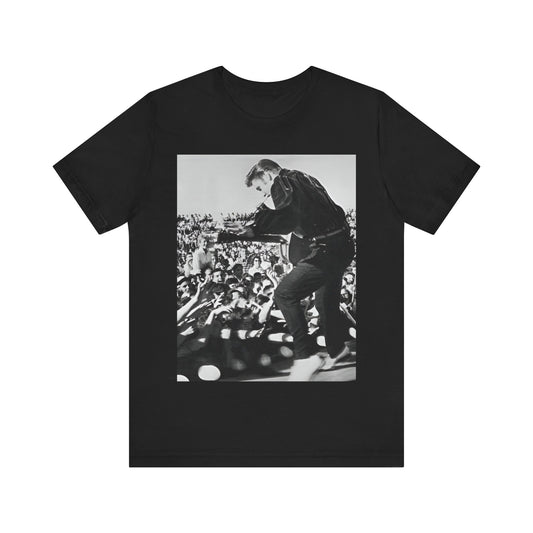 A black graphic t-shirt featuring a retro photo of Elvis Presley performing live in concert in the 1950s.
