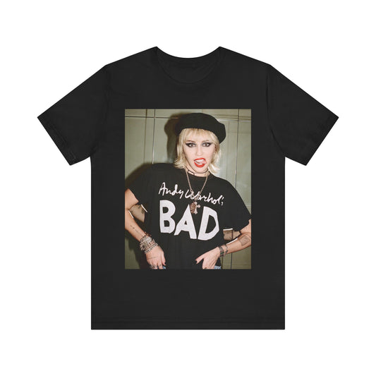 A black graphic t-shirt featuring a graphic related to Miley Cyrus' 'Bad Karma' era.
