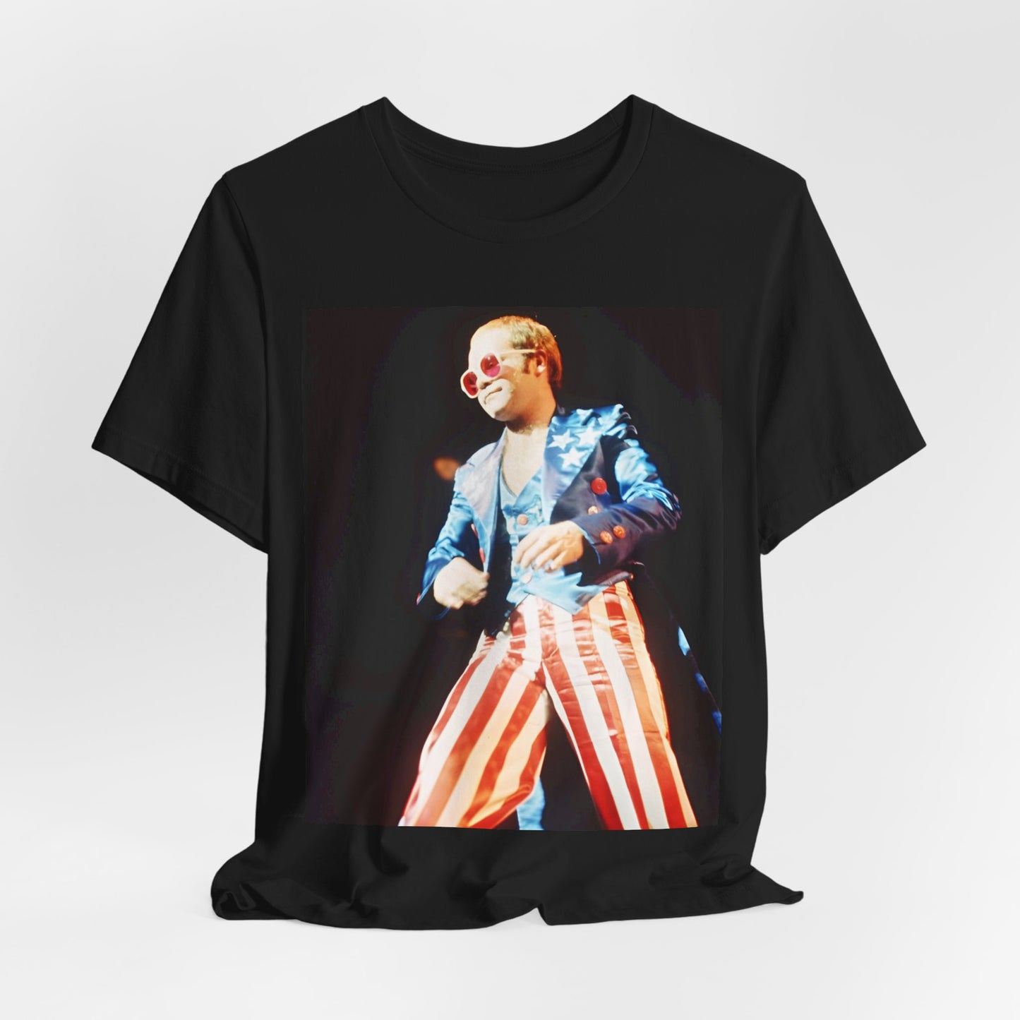 A black graphic t-shirt featuring a graphic related to Elton John's 70s America tour.