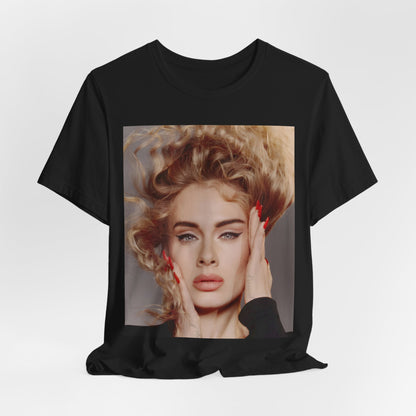 A black graphic t-shirt featuring a detailed, artistic black and white portrait of Adele with her hair dramatically caught in a breeze around her face and her hands gently placed on her cheeks.