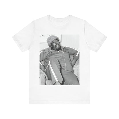 A black graphic t-shirt featuring a 70s-style portrait photo of Barry White in a lounge setting.
