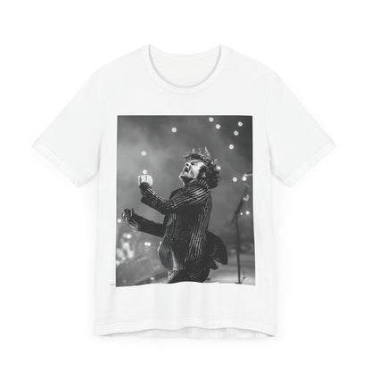 A black graphic t-shirt featuring a glamorous graphic or photo of Harry Styles performing on stage.