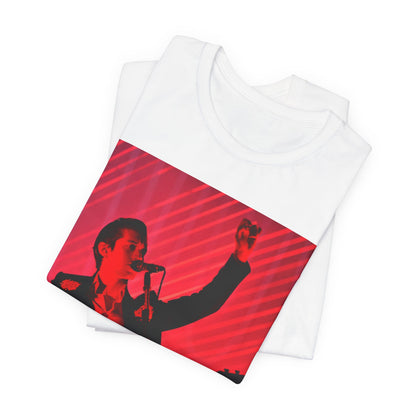 A black graphic t-shirt featuring a dynamic graphic or photo of Arctic Monkeys performing live in concert.