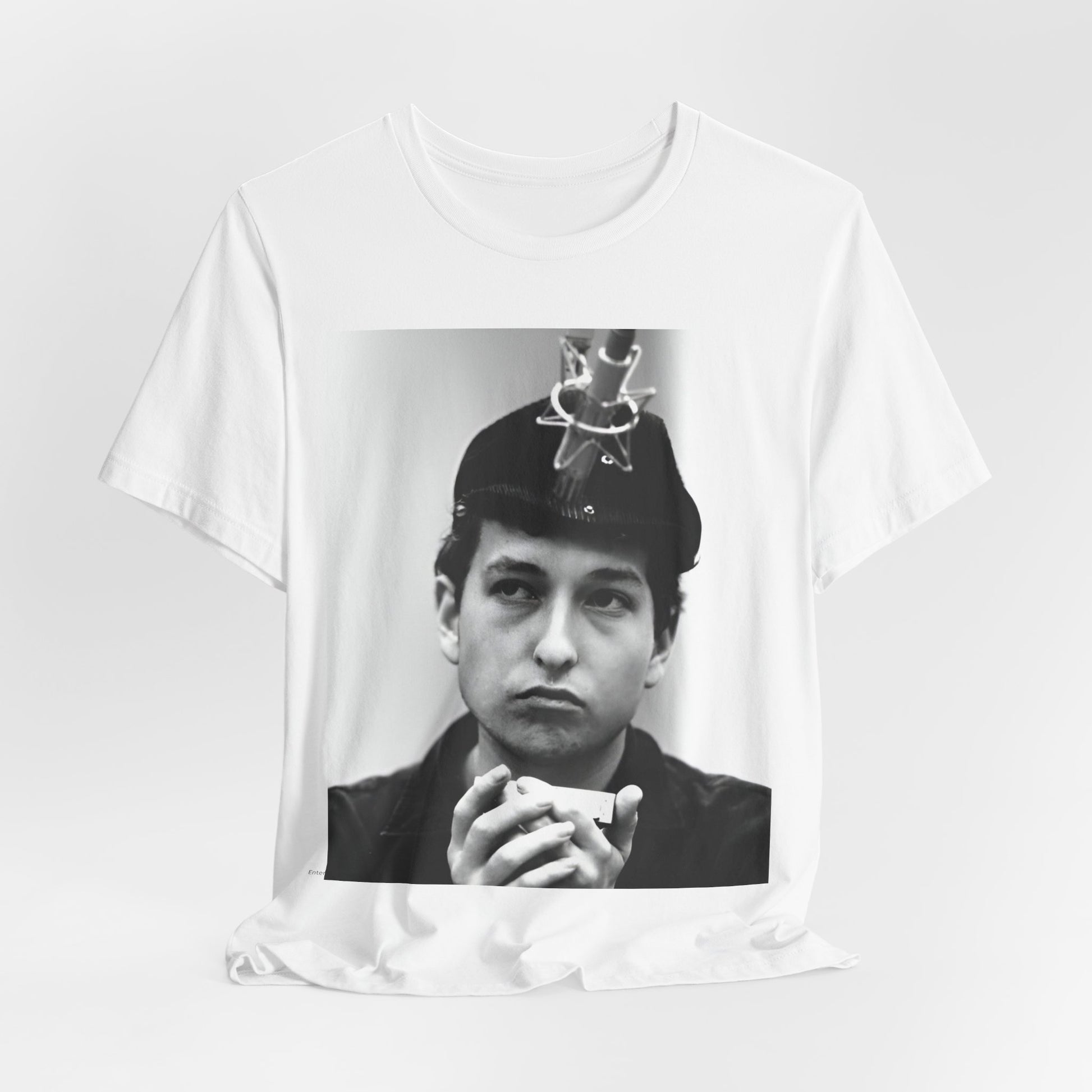 A black graphic t-shirt featuring a graphic of Bob Dylan in an acoustic session setting, possibly with his guitar.