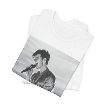A black graphic t-shirt featuring a black and white graphic or photo of Shawn Mendes as a dreamy pop star.