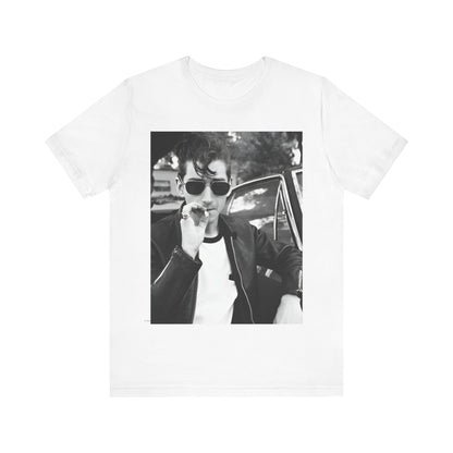 A black graphic t-shirt featuring a classic rock-style graphic of the Arctic Monkeys, possibly with band members in a stylized design.