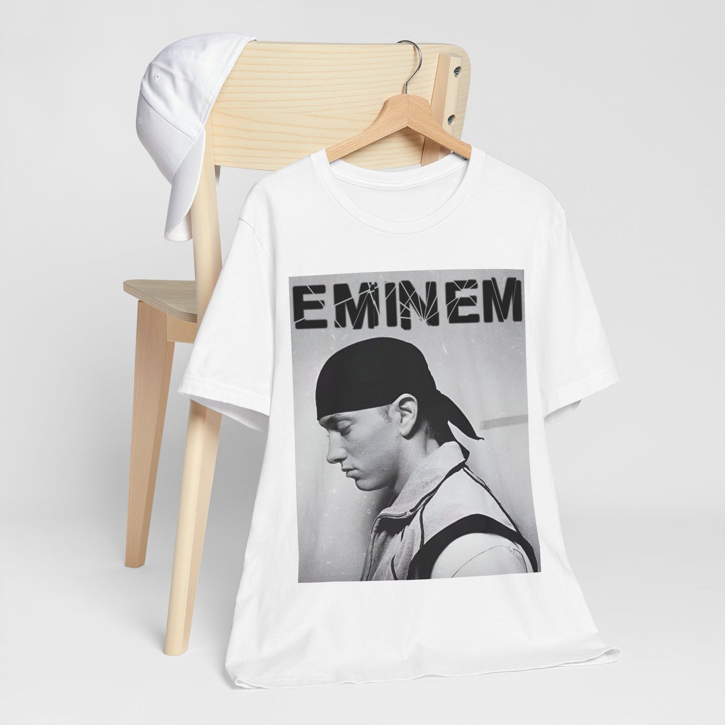 A black graphic t-shirt featuring a stylized graphic of Eminem as a modern rap legend.
