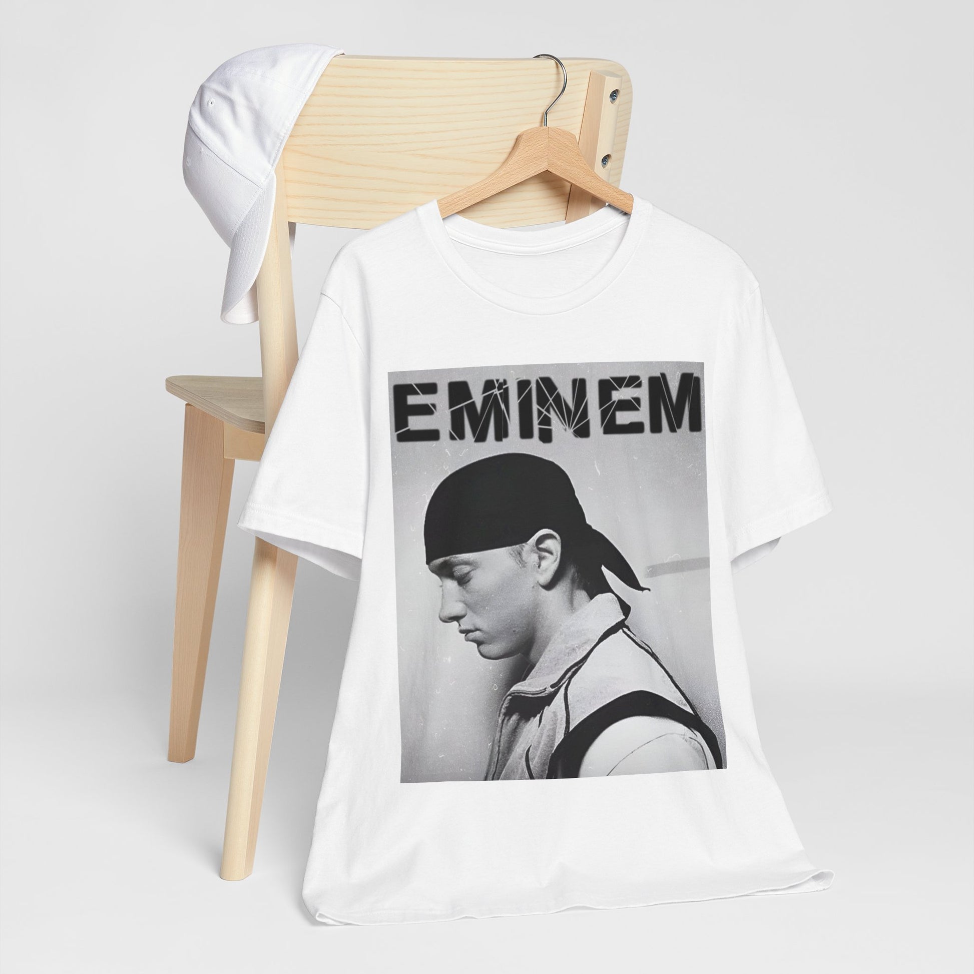 A black graphic t-shirt featuring a stylized graphic of Eminem as a modern rap legend.