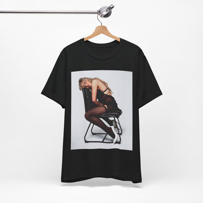 A black graphic t-shirt featuring a playful pop art style graphic of Sabrina Carpenter.
