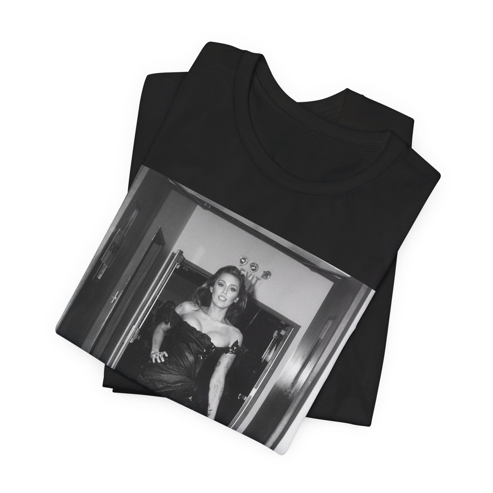 A black graphic t-shirt featuring a black and white graphic of Miley Cyrus in a cool pop rock style.
