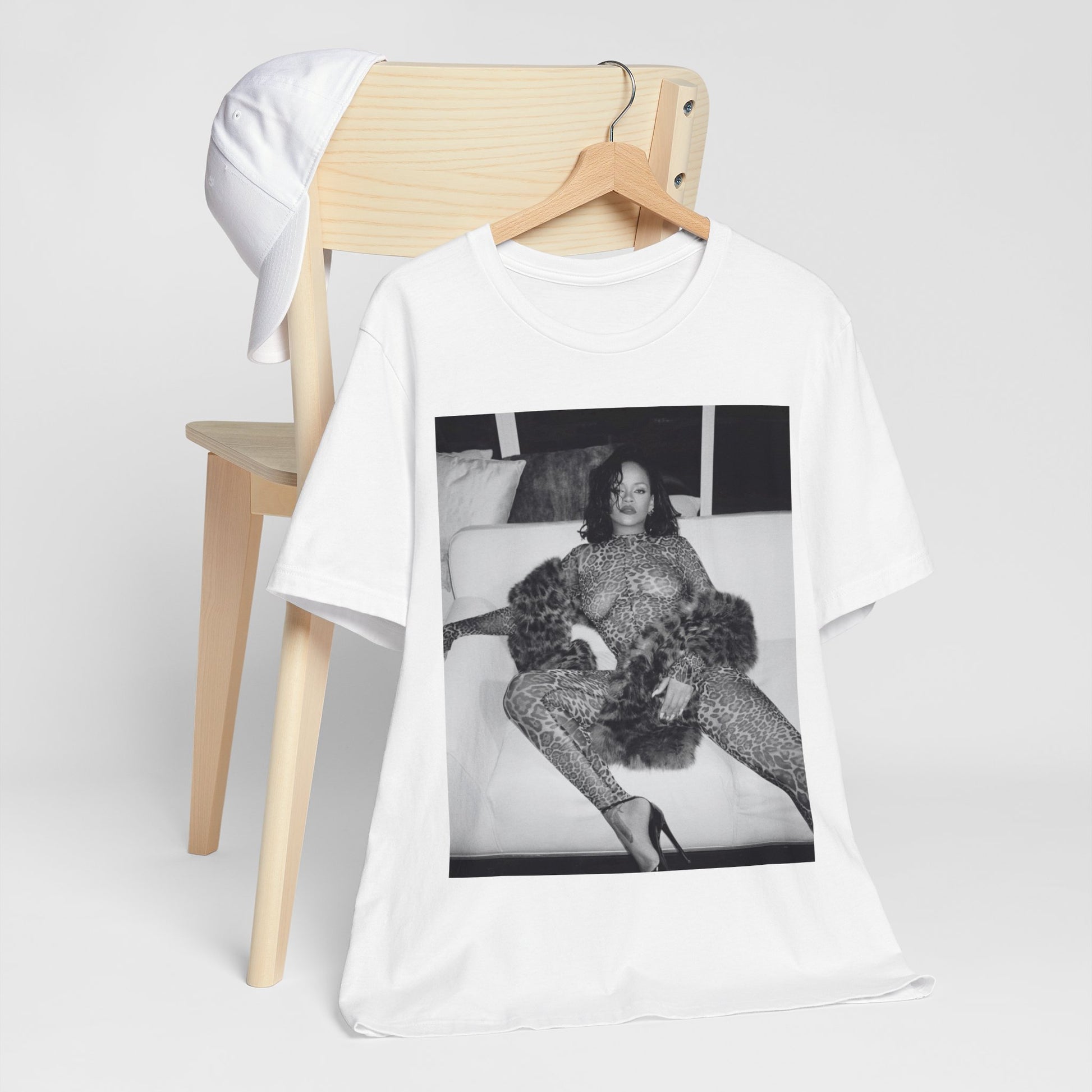 A black graphic t-shirt featuring a black and white, monochrome graphic or photo of Rihanna in a sexy pose.