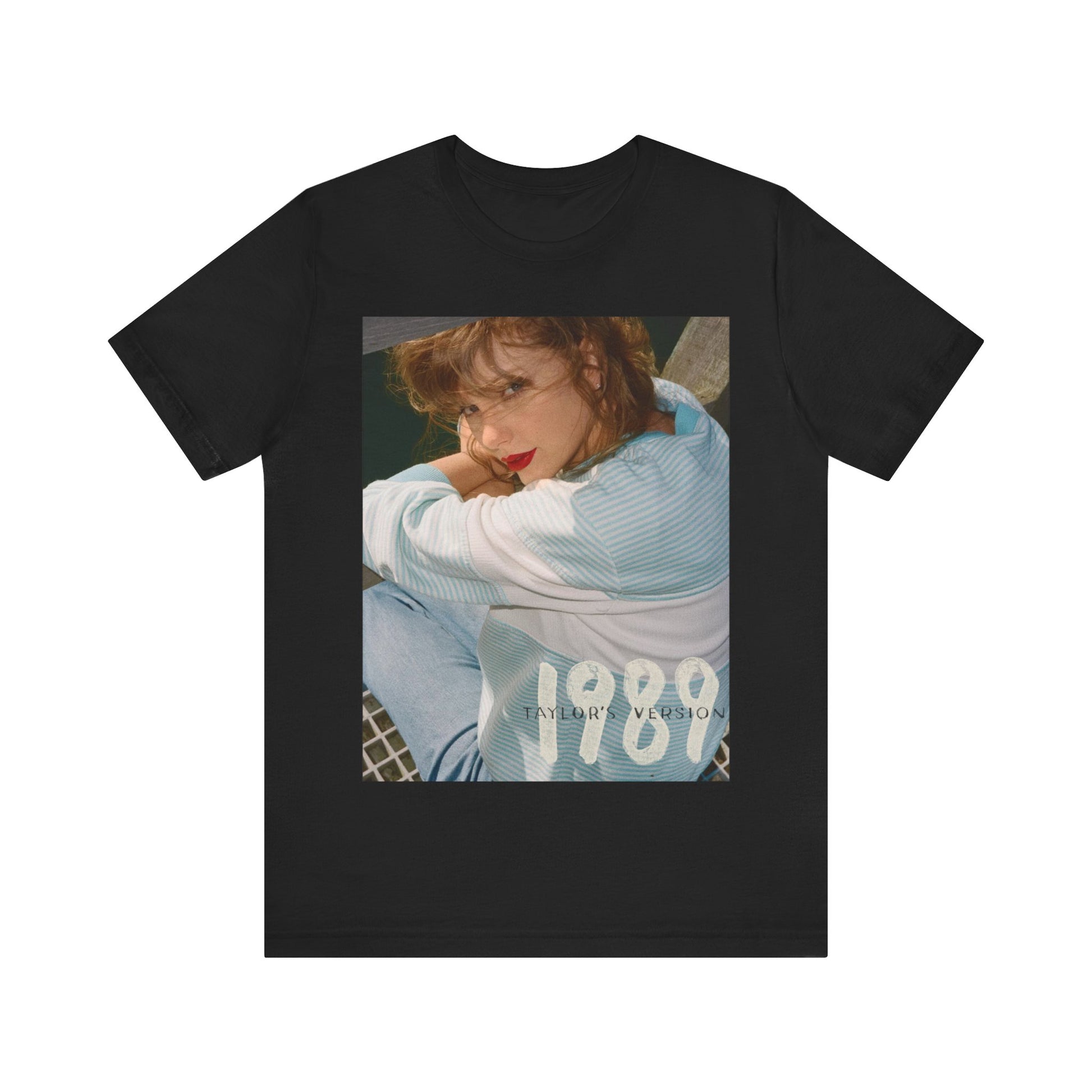 A black graphic t-shirt featuring a 1989 aesthetic graphic of Taylor Swift.