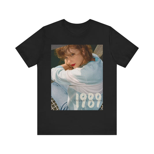 A black graphic t-shirt featuring a 1989 aesthetic graphic of Taylor Swift.