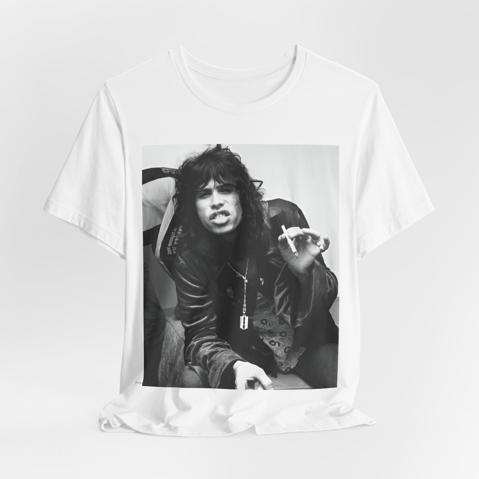 A black graphic t-shirt featuring a retro 70s photo of Aerosmith band members lounging in leather, exuding a cool, classic rock vibe.