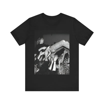A black graphic t-shirt featuring a 90s graphic or photo of Kurt Cobain from Nirvana stage diving.