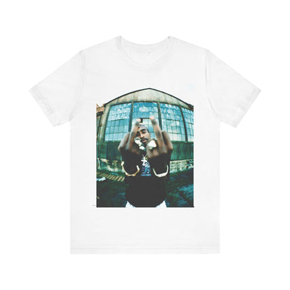 A black graphic t-shirt featuring a graphic of Tupac giving the middle finger.