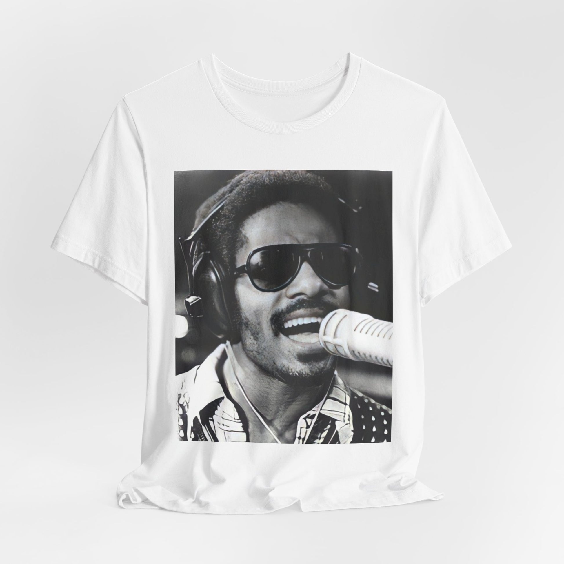 A black graphic t-shirt featuring a graphic of Stevie Wonder as a timeless visionary.