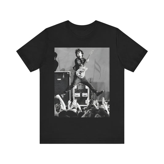 A black graphic t-shirt featuring a graphic of Billie Joe Armstrong from Green Day jumping on stage during a performance.