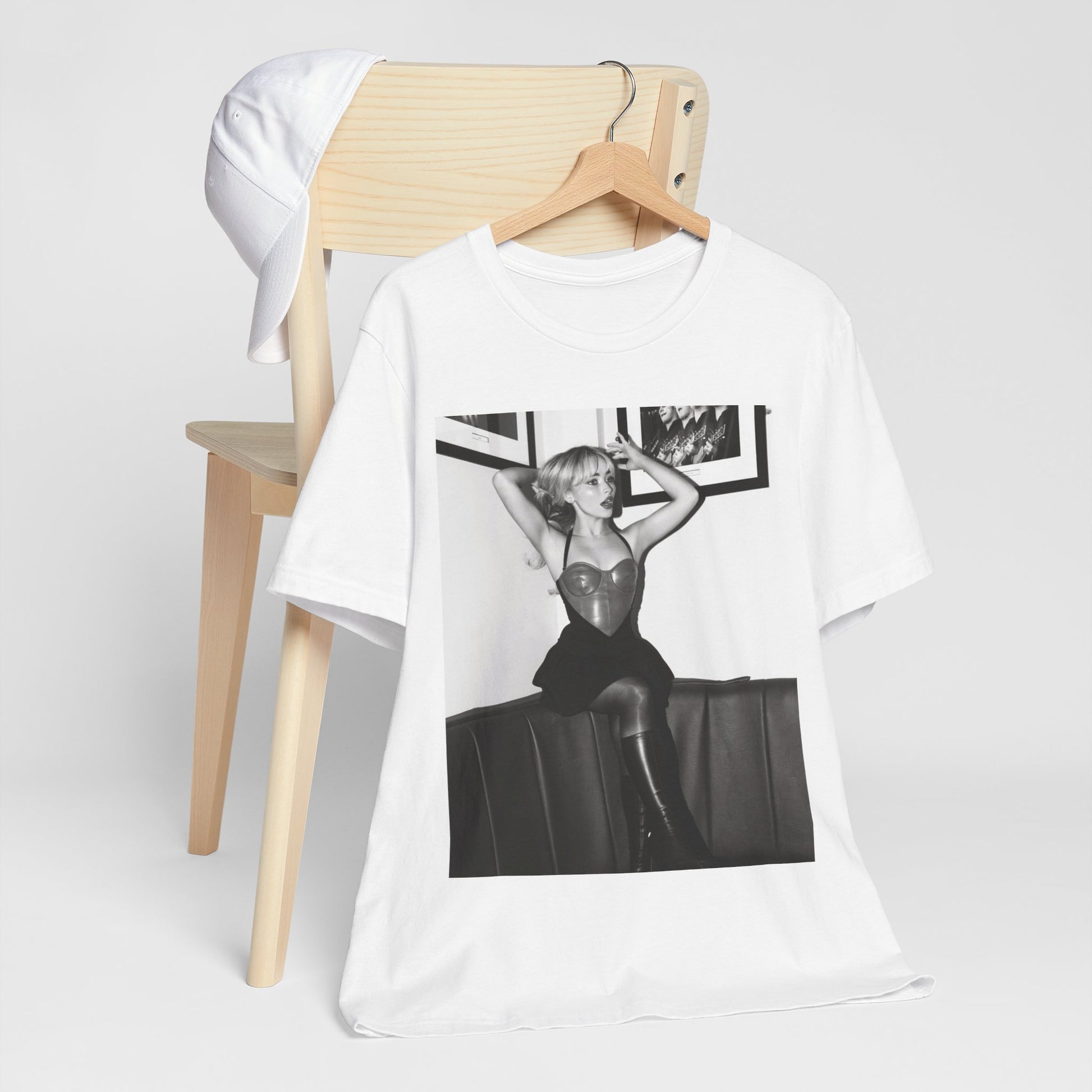 A black graphic t-shirt featuring a black and white graphic of Sabrina Carpenter as a pop princess.