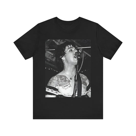 A black graphic t-shirt featuring a black and white graphic or photo of Green Day performing live on stage.