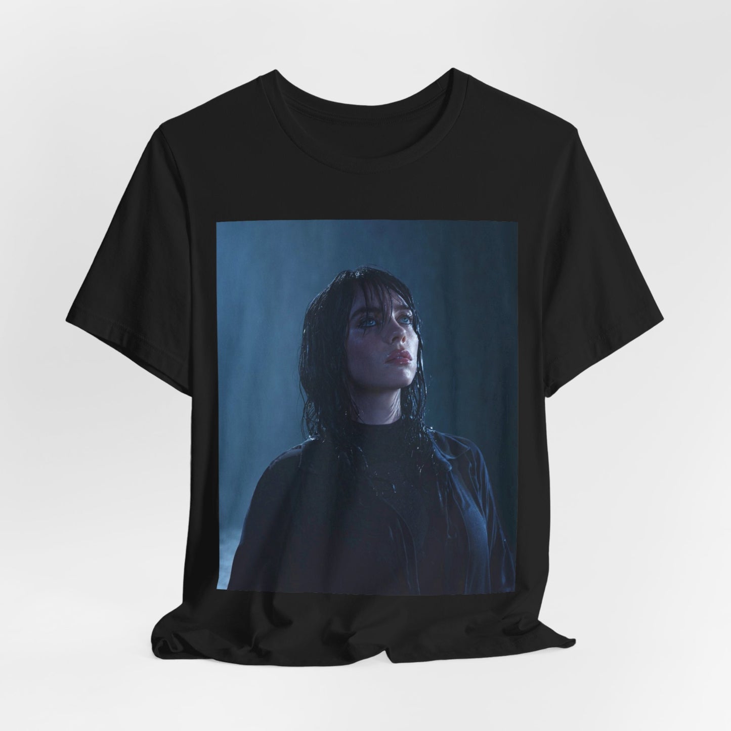 A direct, powerful portrait of Billie Eilish, embodying the 'HIT ME HARD AND SOFT' album era, printed on a graphic t-shirt.