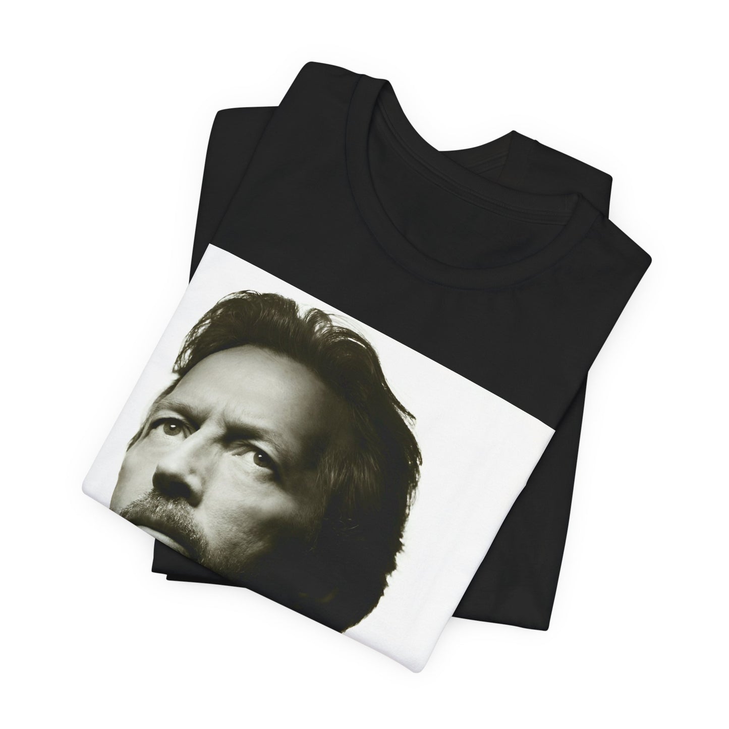 A black graphic t-shirt featuring a retro black and white portrait photo of Eric Clapton.