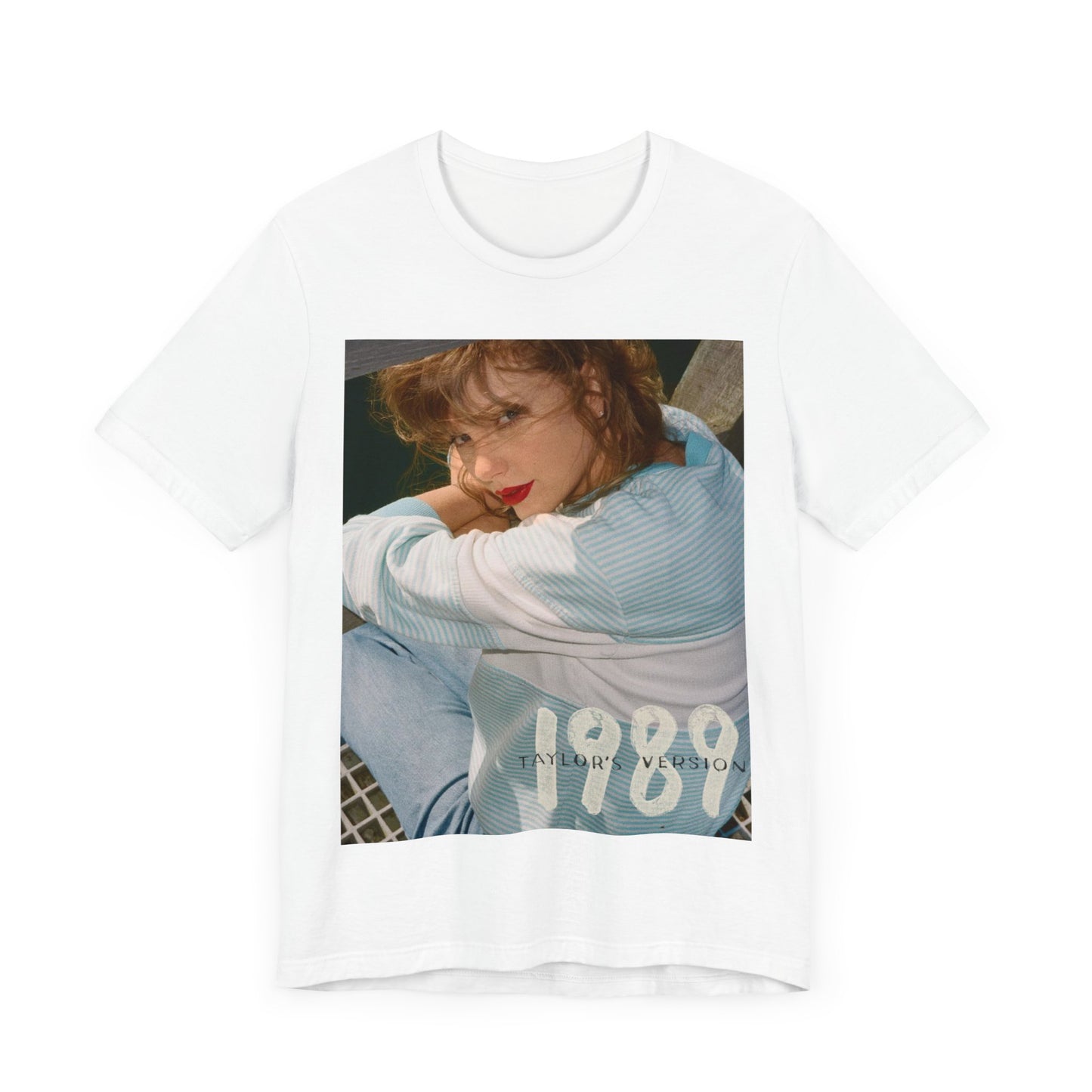 A black graphic t-shirt featuring a 1989 aesthetic graphic of Taylor Swift.