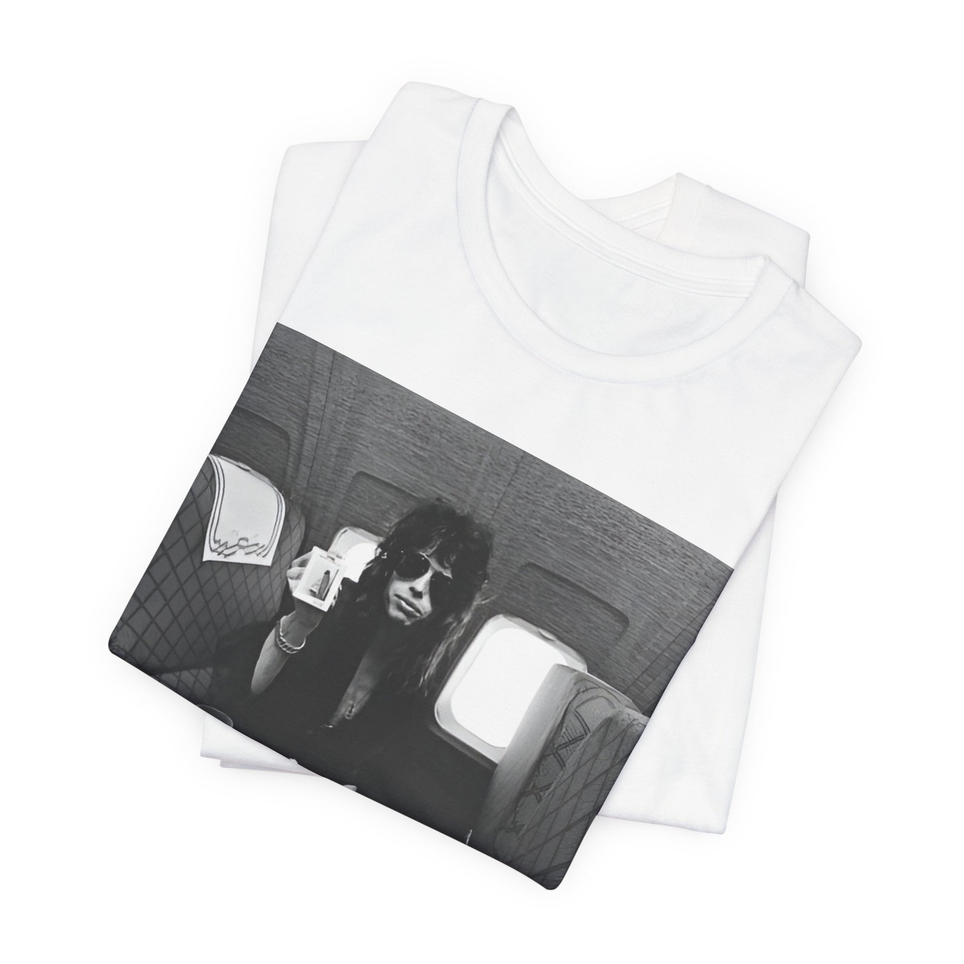 A black graphic t-shirt featuring a vintage 70s-style illustration of an airplane with Aerosmith branding, representing their tour plane from that era.