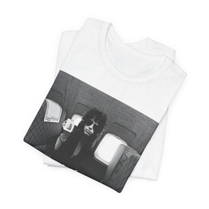 A black graphic t-shirt featuring a vintage 70s-style illustration of an airplane with Aerosmith branding, representing their tour plane from that era.
