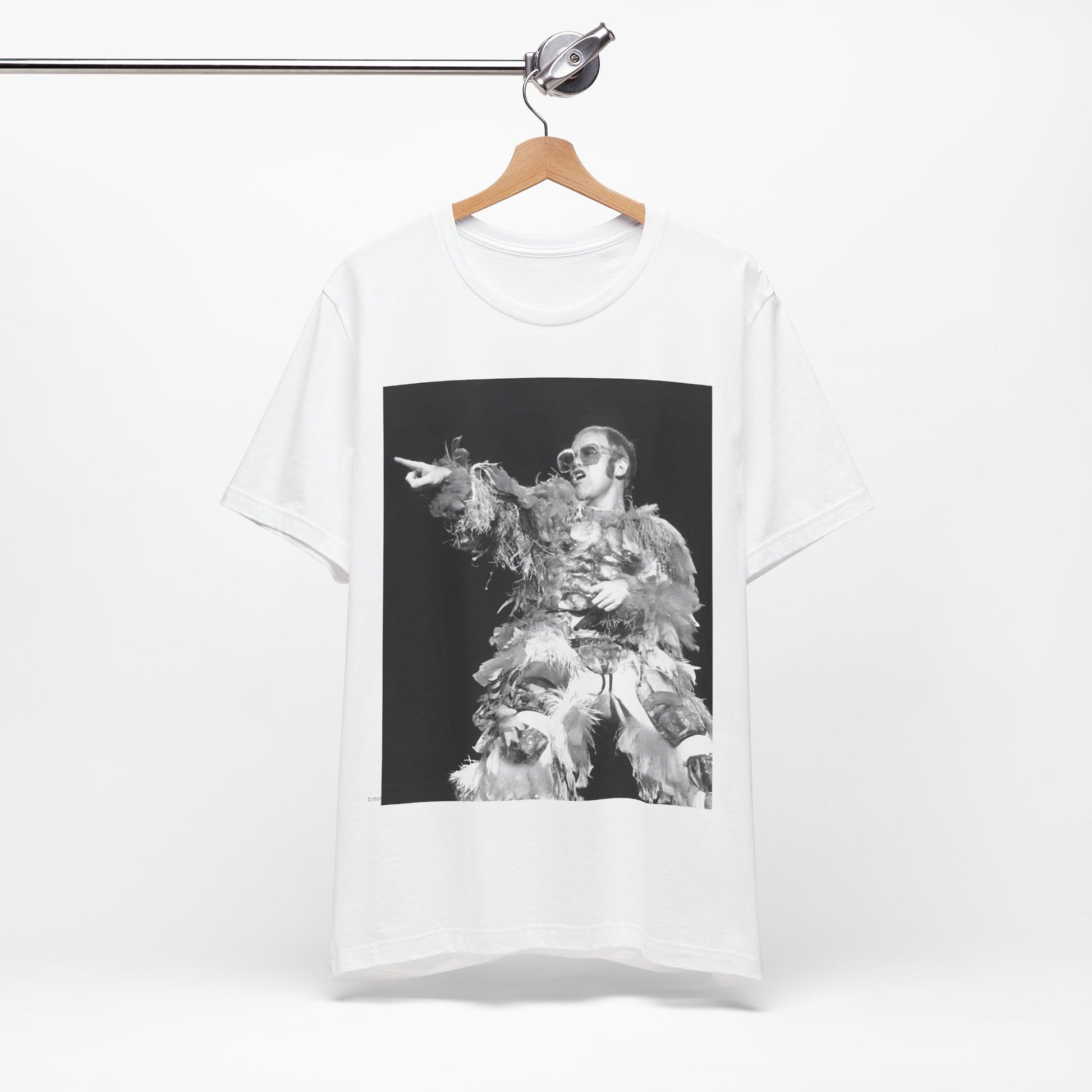 A black graphic t-shirt featuring a retro graphic of Elton John as a rock legend performing live.